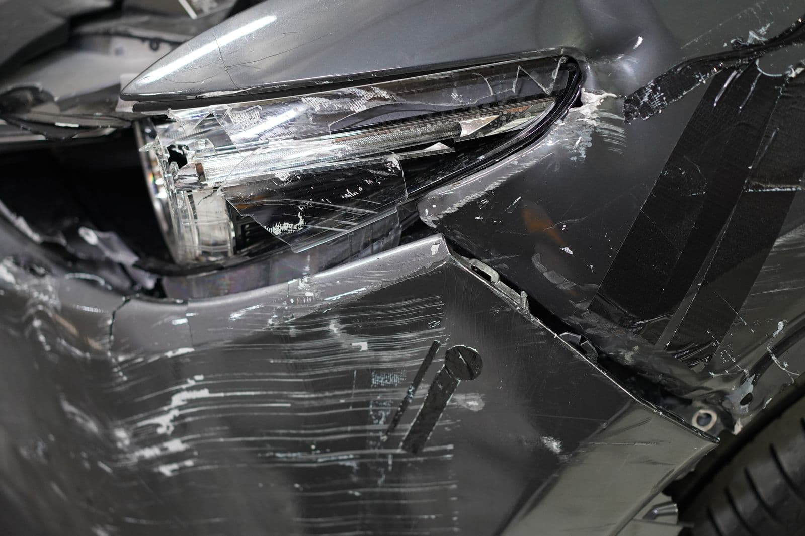 Accident damage on a car front end being assessed at Solis Panelbeaters