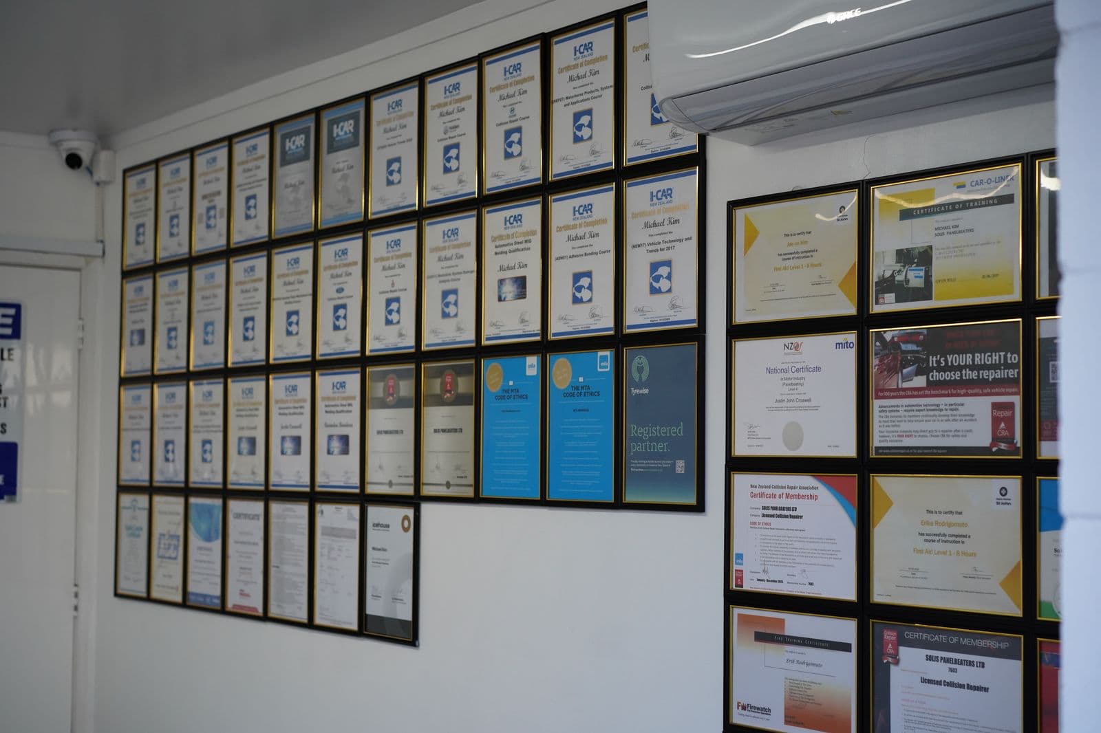 Wall of certifications and awards at Solis Panelbeaters reception