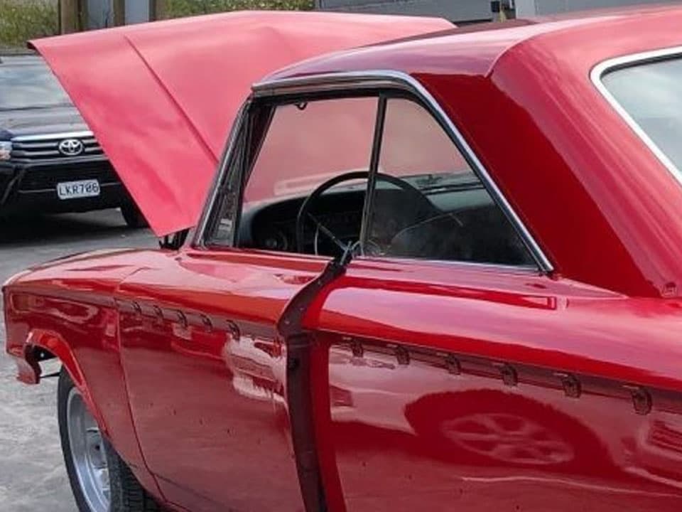 Restored classic car with deep red paint finish