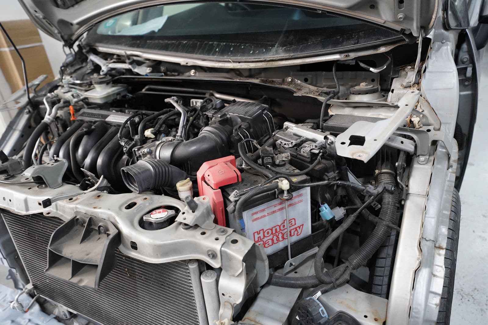 Engine bay open for inspection during a service at Solis Panelbeaters