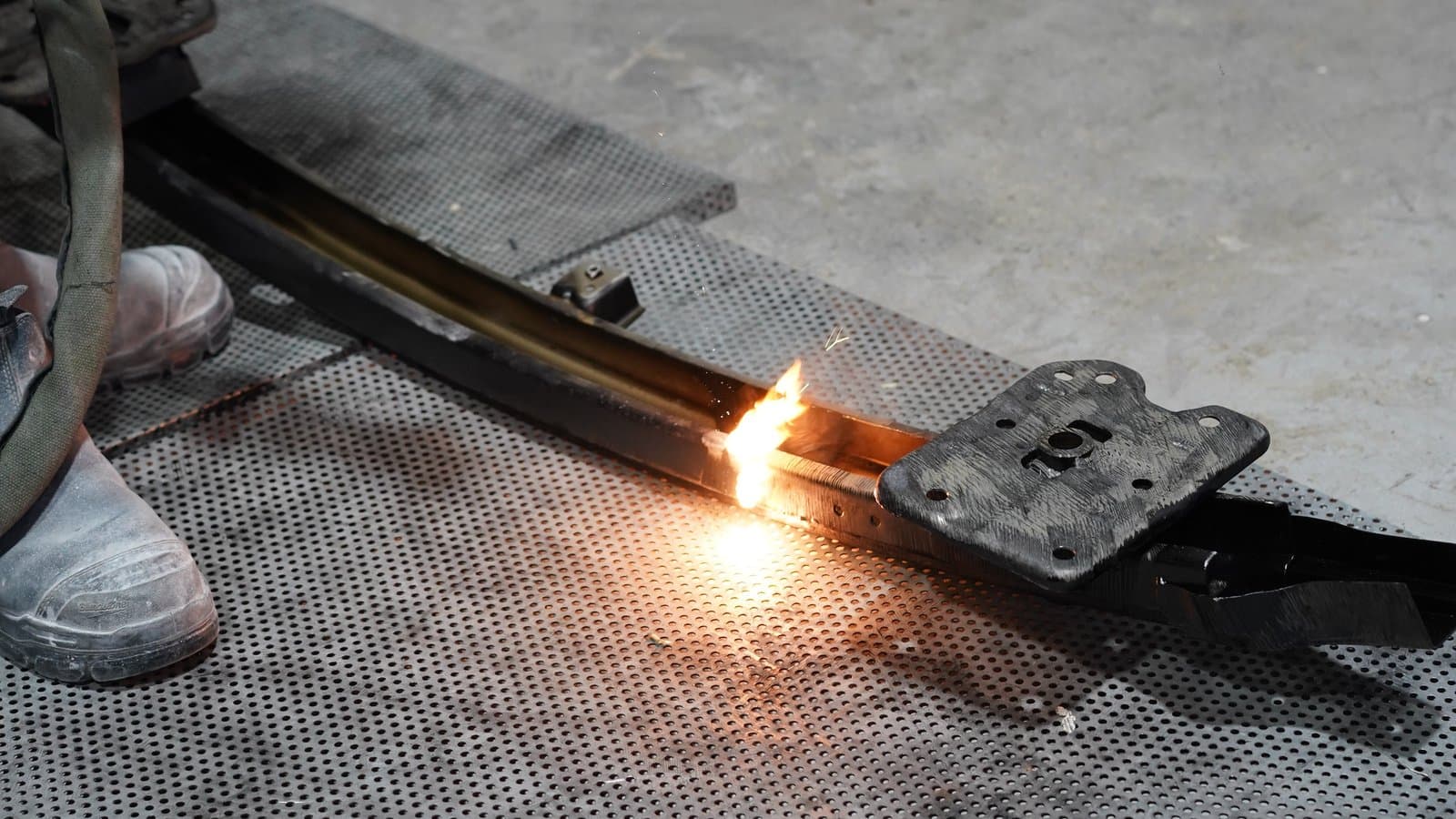Rust being removed from a steel component at Solis Panelbeaters