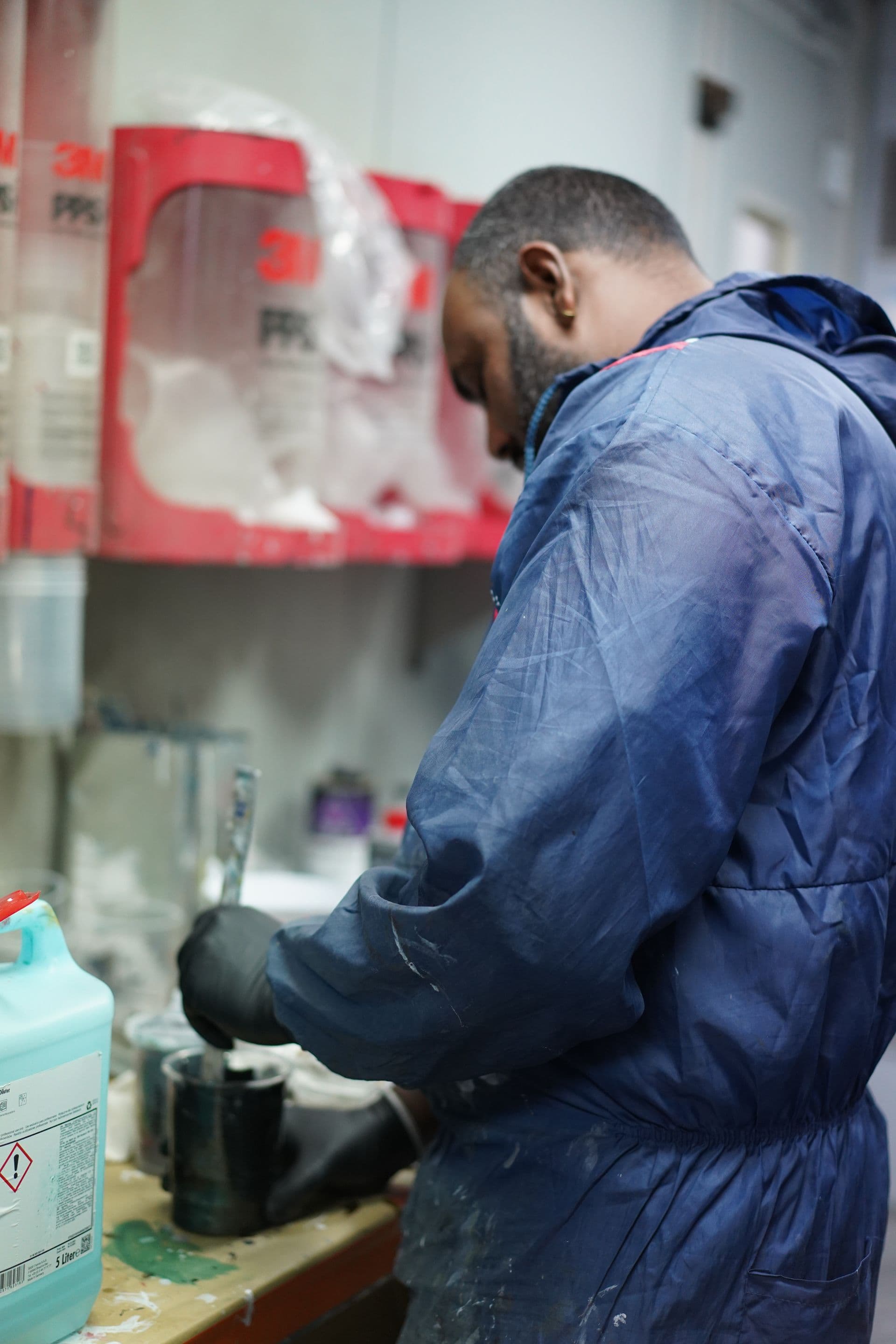 Technician mixing paint in the Solis mixing room